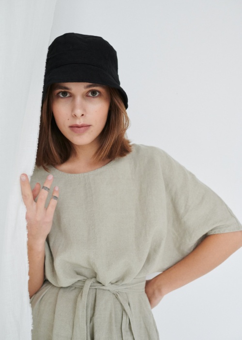 Model with linen dress and bucket hat