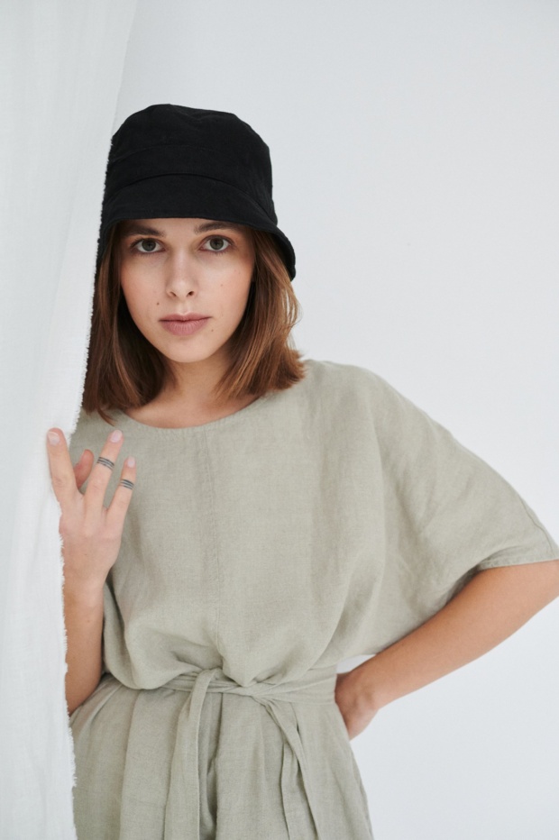 Model with linen dress and bucket hat