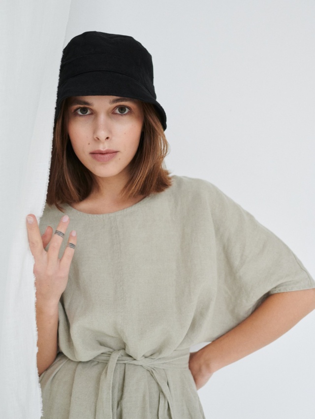 Model with linen dress and bucket hat