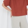 A lady in boxy oversized linen top