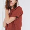 A woman in short sleeve brown top made from natural linen