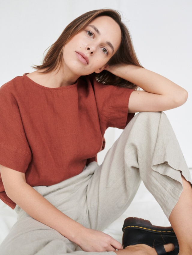 A model wearing an oversized short sleeve linen top