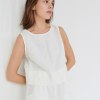 Model wearing white linen crop top
