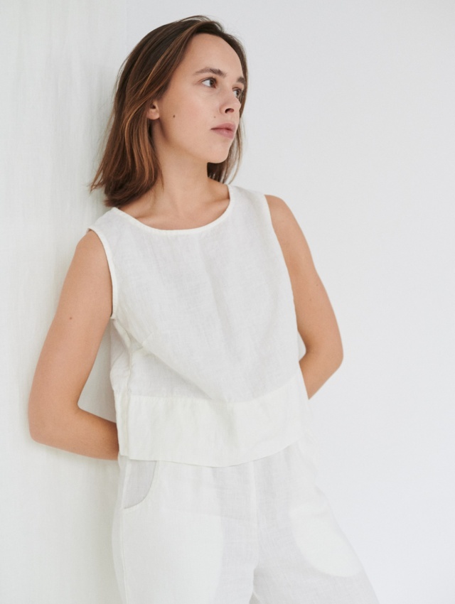 Model wearing white linen crop top