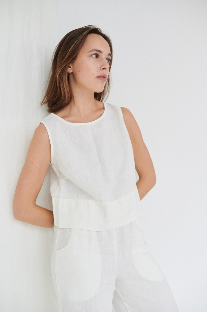 Model wearing white linen crop top