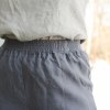Elastic waistband of natural linen trousers in graphite grey