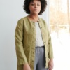 Women wearing heavy linen jacket with deep pockets and metal snaps
