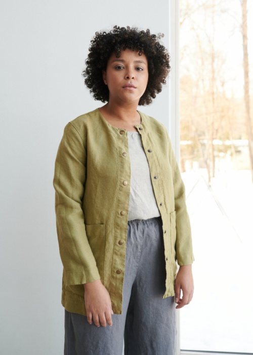 Women wearing heavy linen jacket with deep pockets and metal snaps