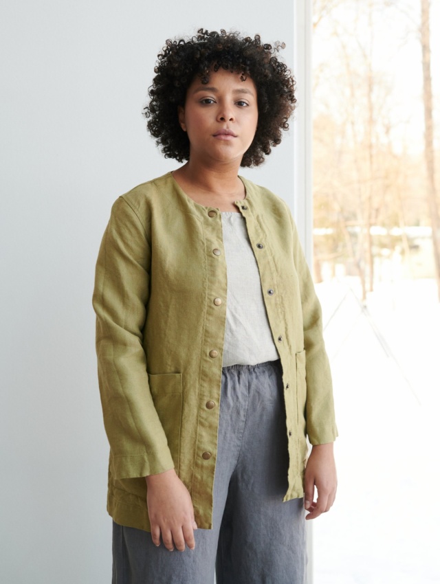 Women wearing heavy linen jacket with deep pockets and metal snaps