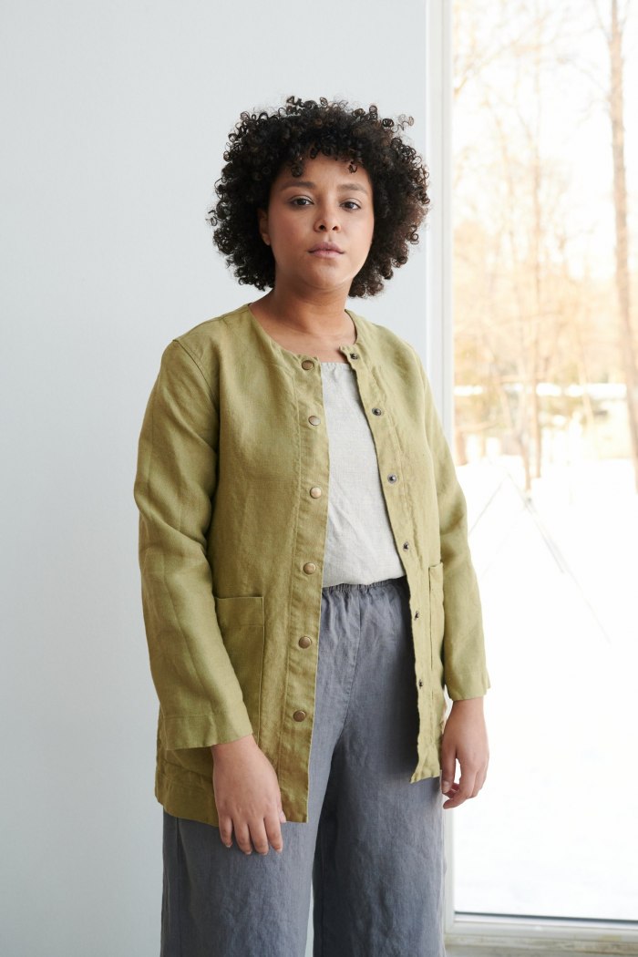 Women wearing heavy linen jacket with deep pockets and metal snaps