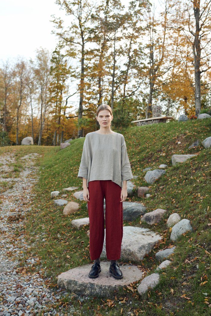A woman in red wide leg linen trousers