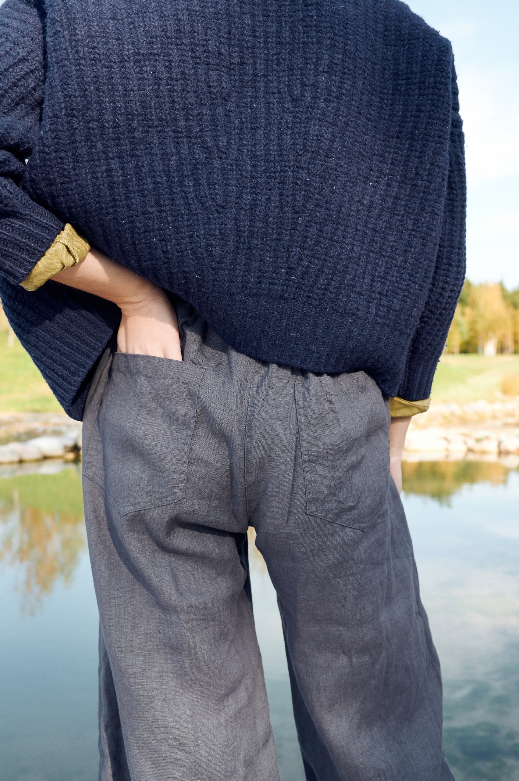 Back pockets of linen dark grey trousers