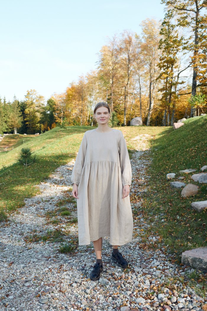 Linenfox model wearing beige linen smock dress