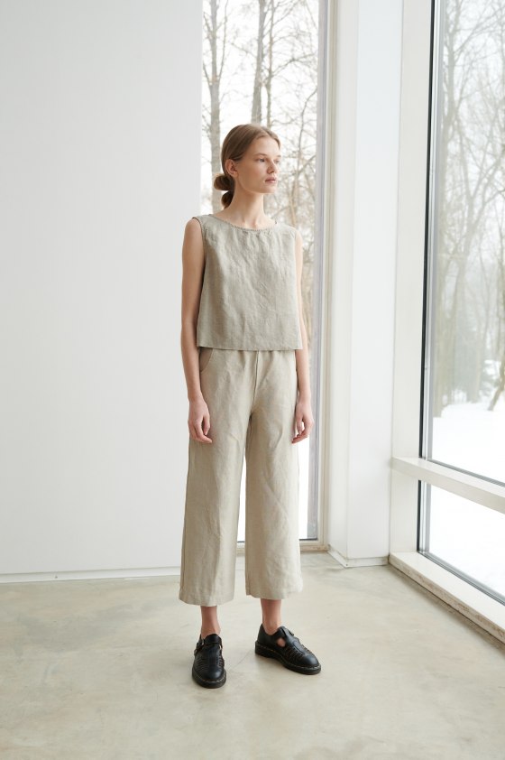 A woman in wide leg trousers from natural linen