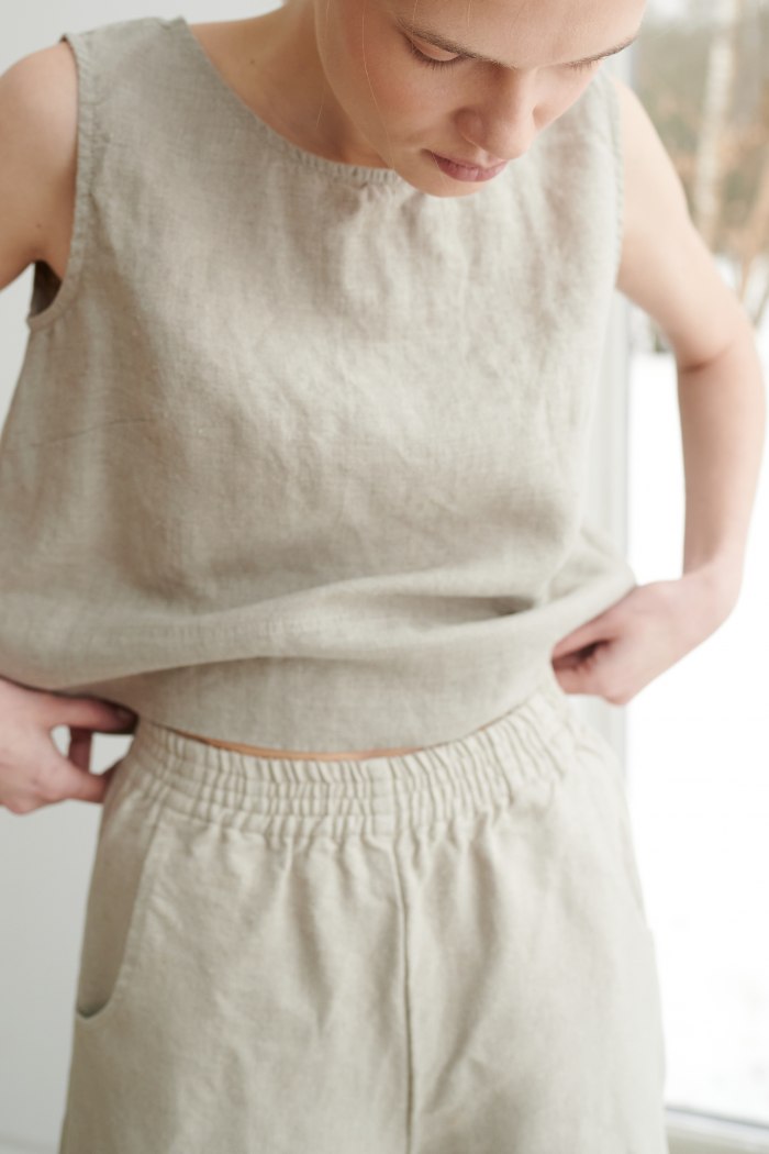 A woman in natural grey linen trousers with elastic waistband