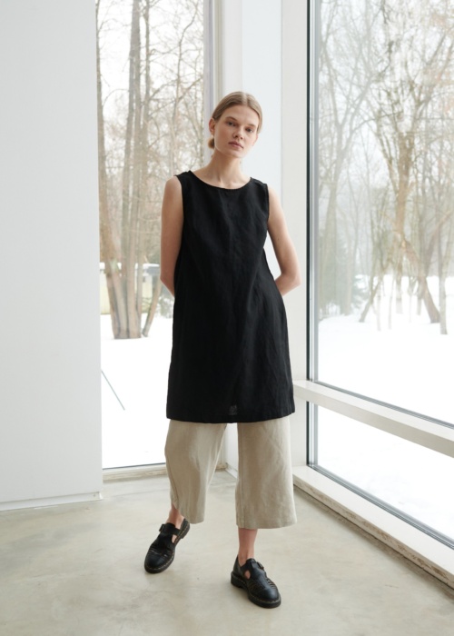 Model wearing sleeveless black linen dress