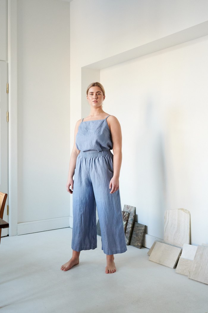Linenfox model standing in wide leg linen trousers and a matching top