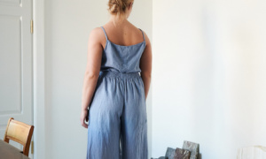 The back of a model wearing wide leg blue linen trousers