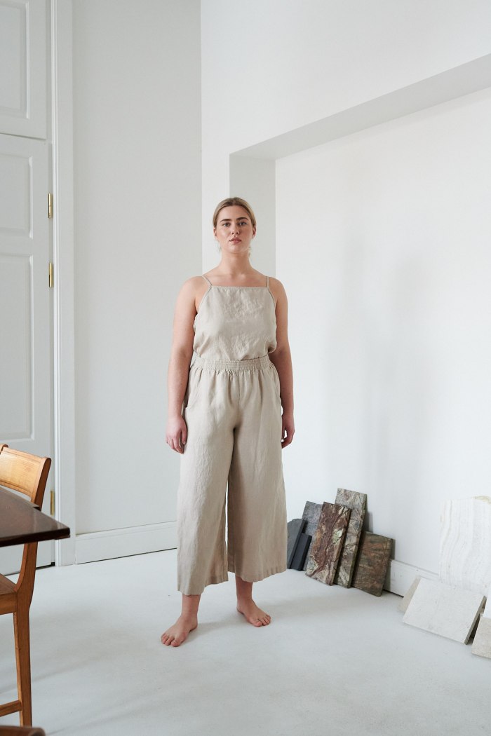 A model in beige wide leg trousers