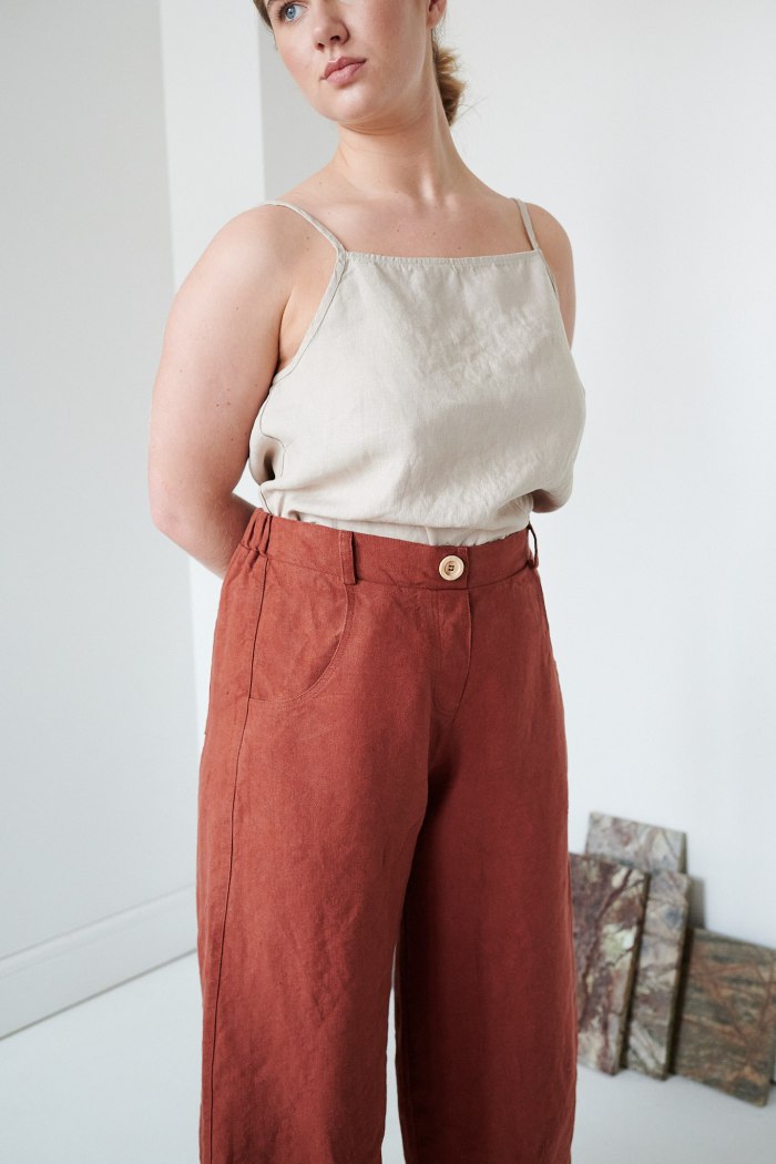 The waistband of brown heavy linen trousers