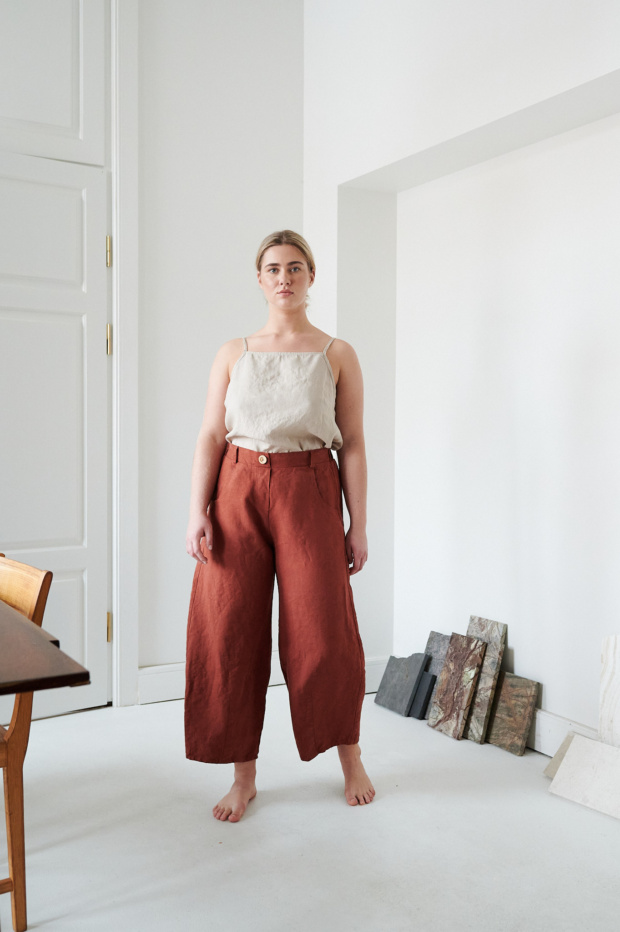 A woman wearing the heavy linen terracotta pants