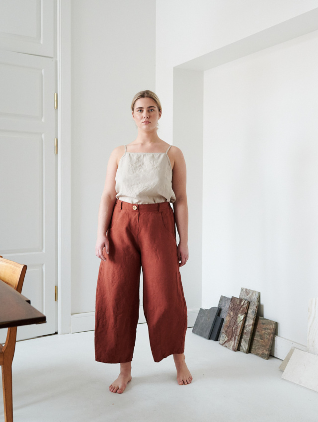 A woman wearing the heavy linen terracotta pants