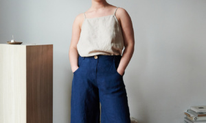 A model in dark blue heavy linen trousers