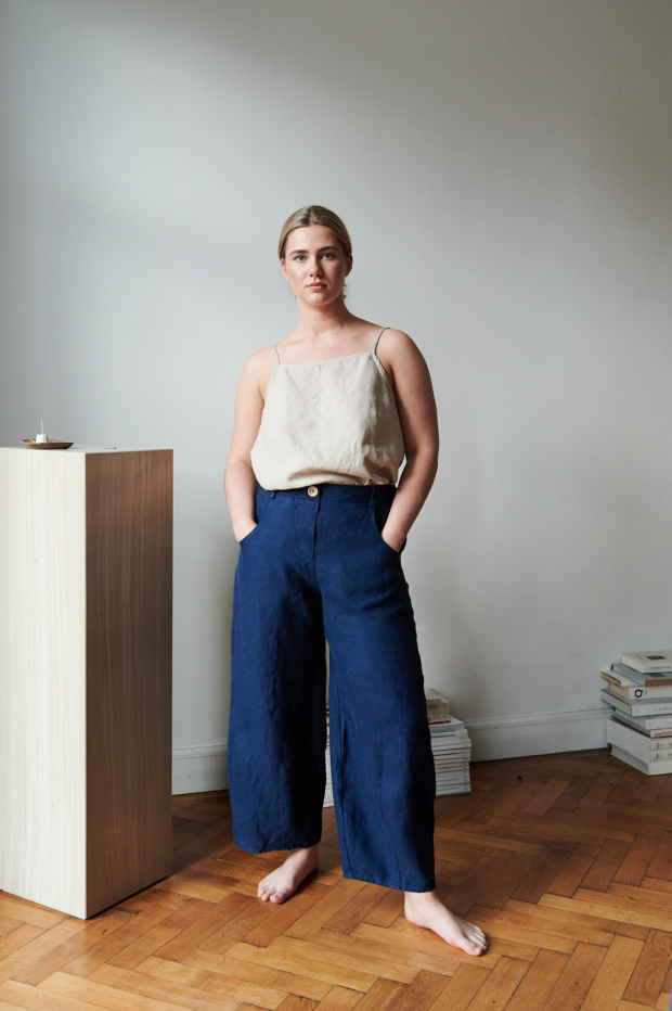 A model in dark blue heavy linen trousers