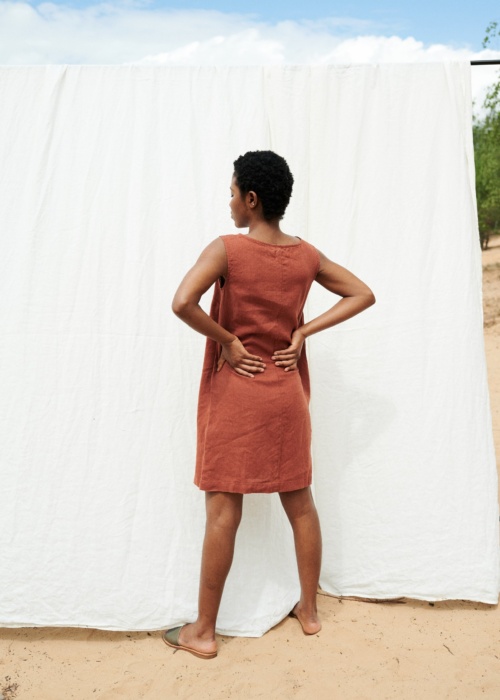 Women wearing sleeveless loose dress in terracotta