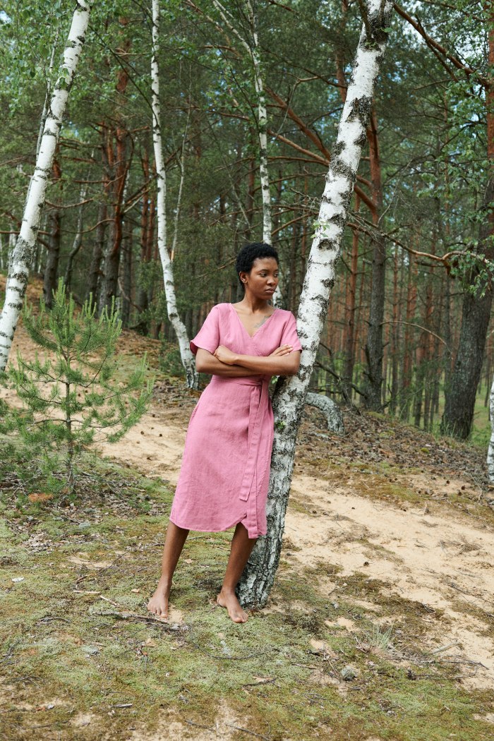 A woman in pink linen summer wrap dress