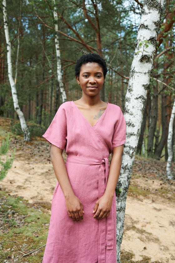 The front of a pink linen wrap dress