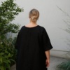 A black oversized linen dress with flared wide sleeves