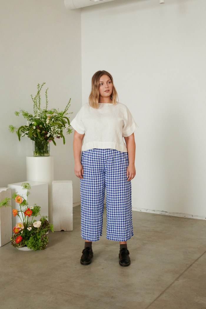 A model in wide leg linen trousers in blue gingham