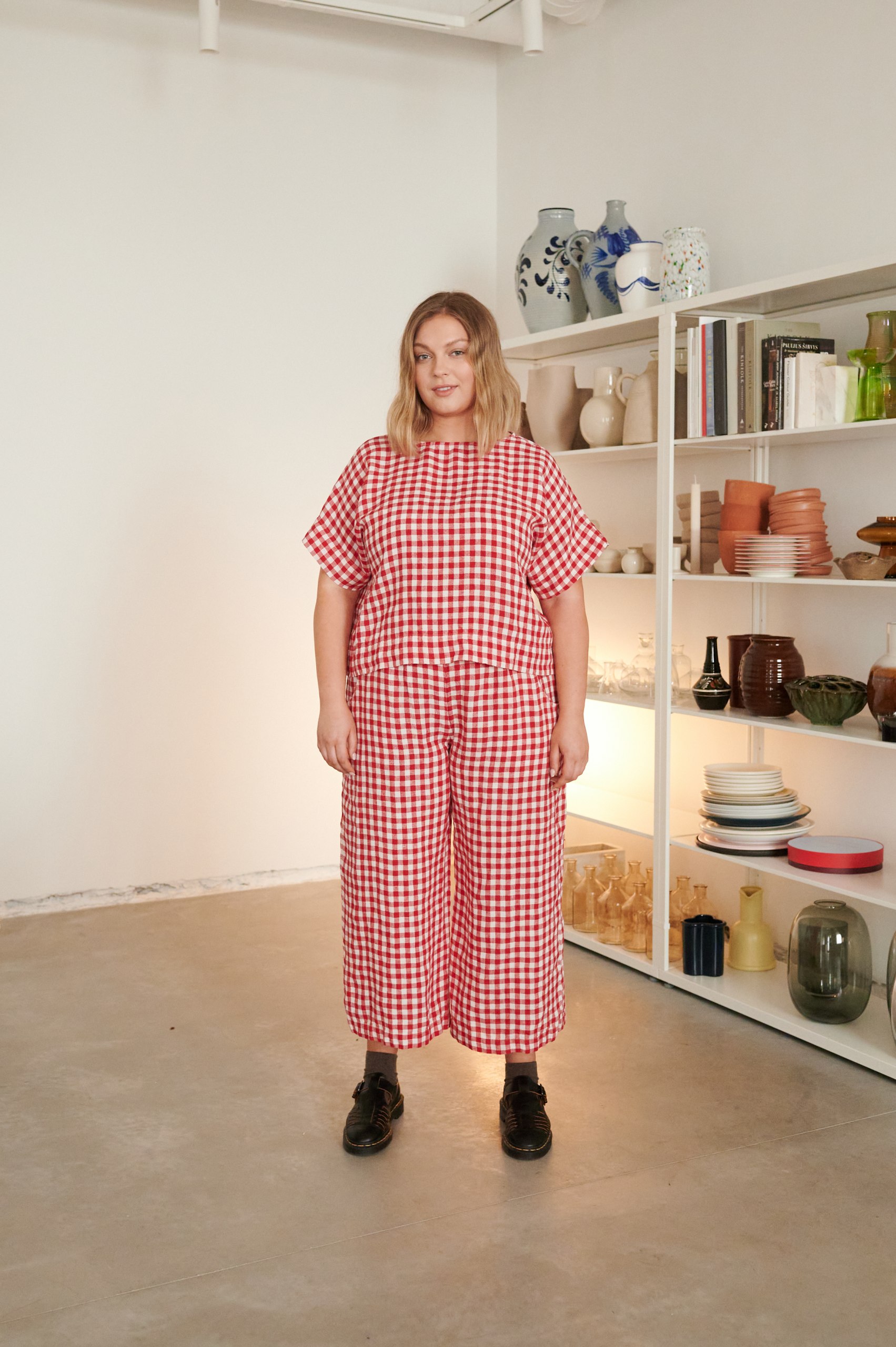 A model in red gingham wide leg linen trousers