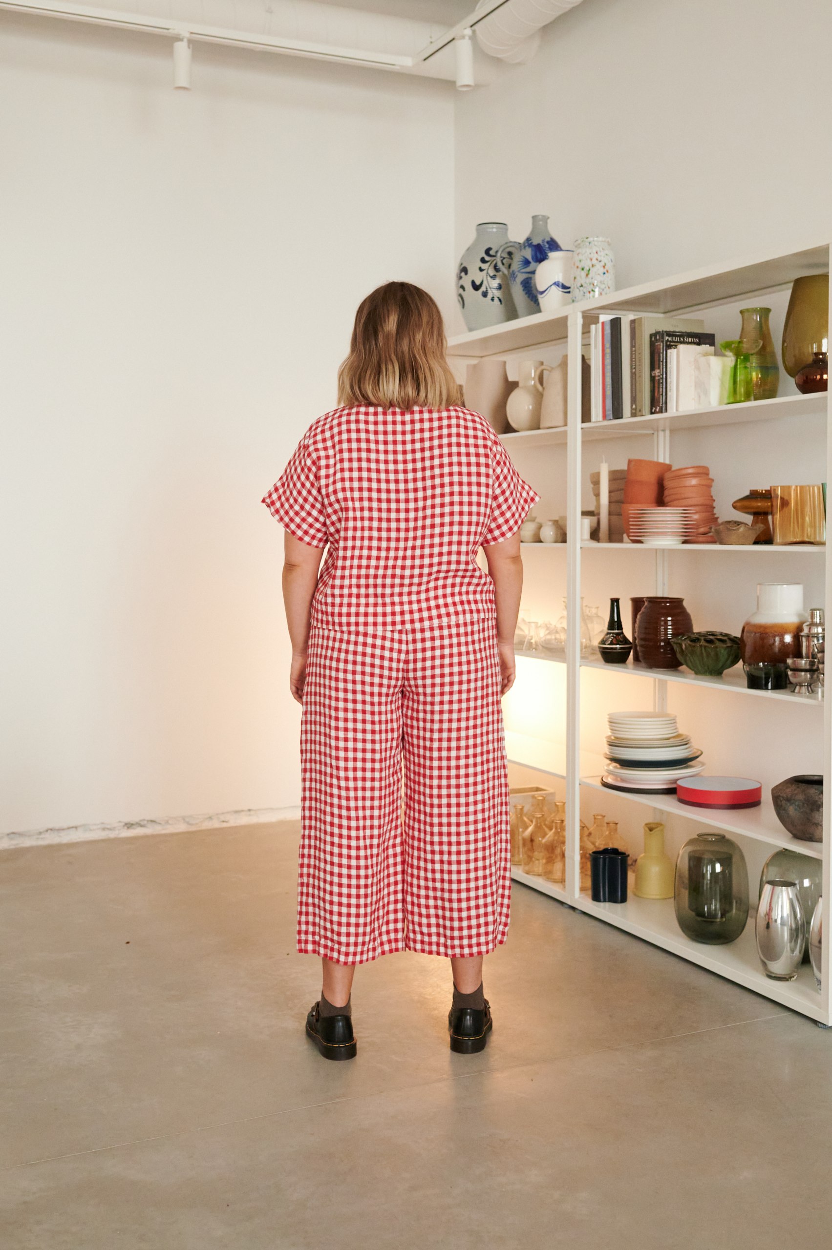 The back of high waisted red gingham linen trousers