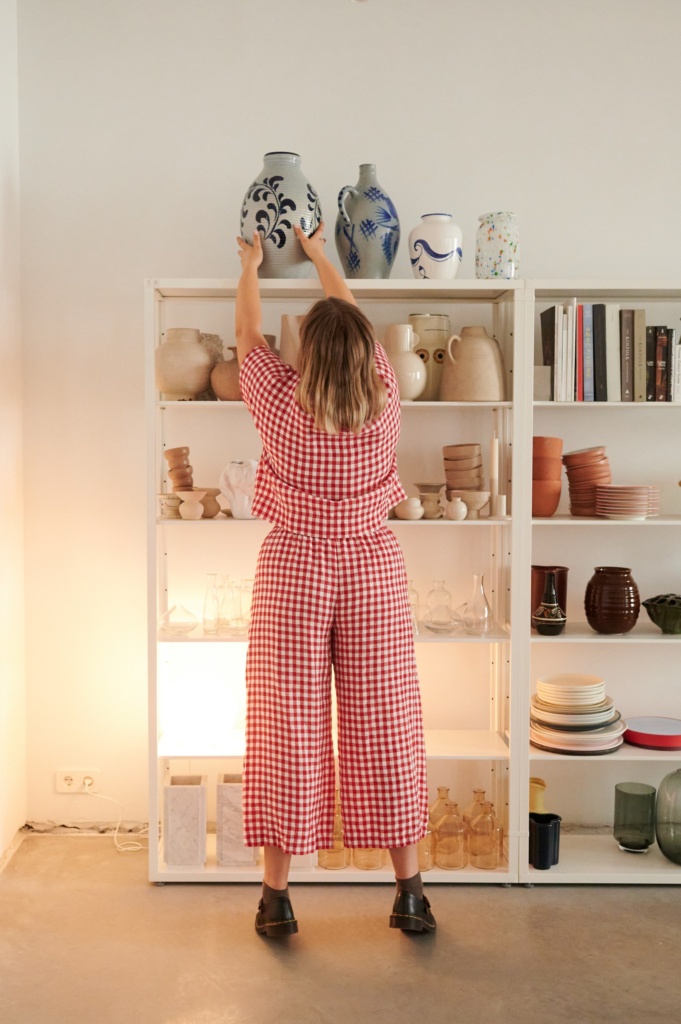 The model is wearing high waisted linen pants in red gingham 