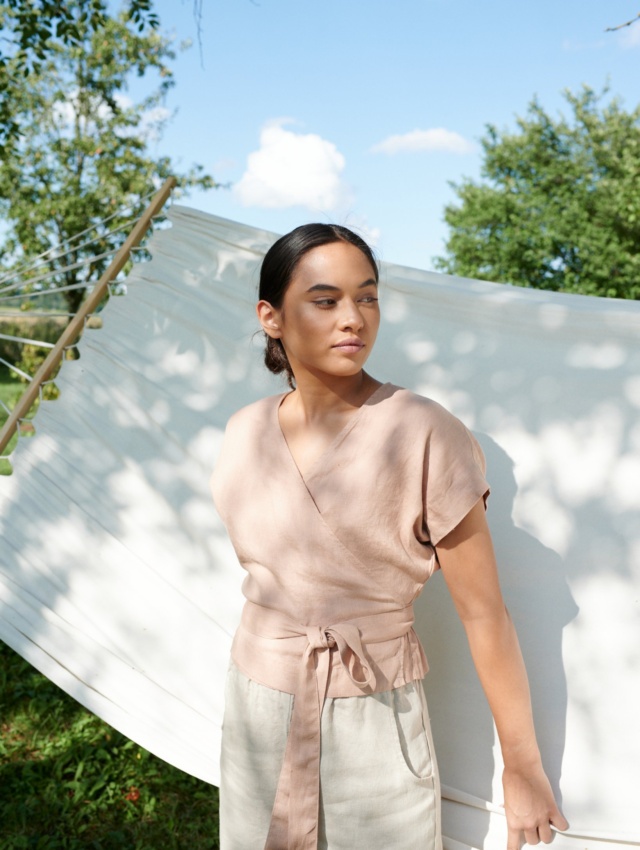 Woman wearing kimono sleeve top by the hammock