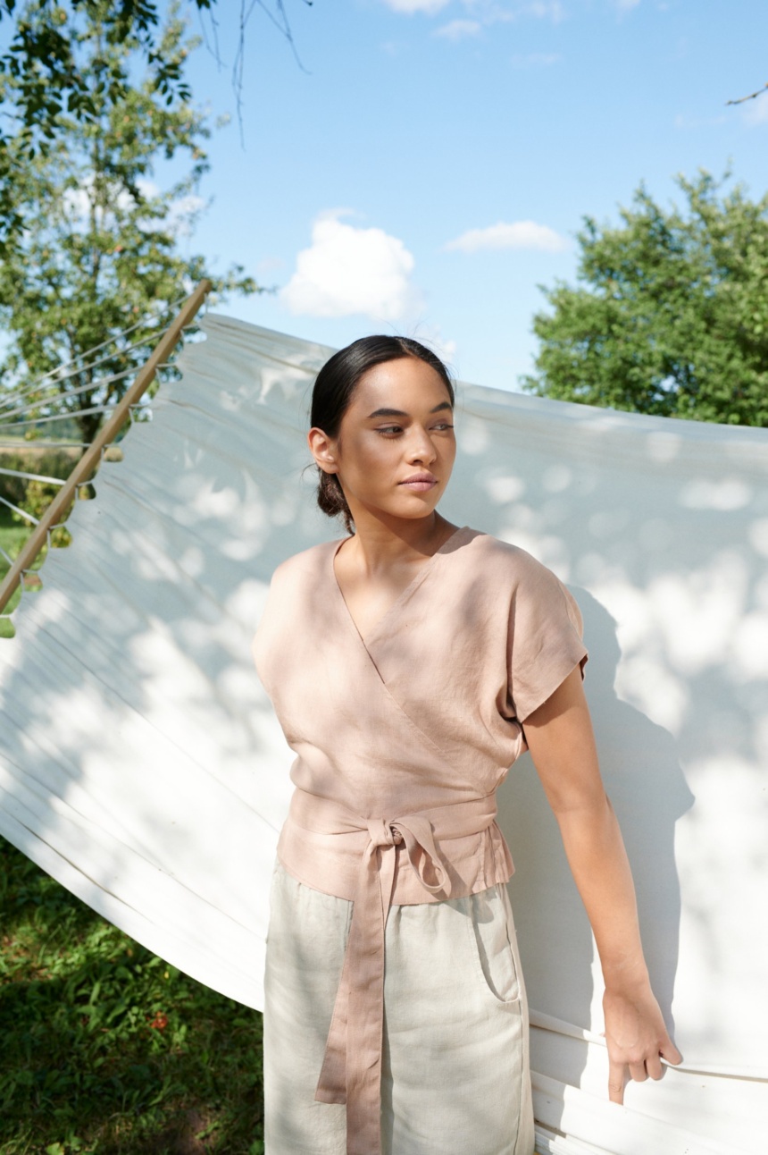 Woman wearing kimono sleeve top by the hammock