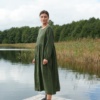 Woman in dark green oversized linen dress