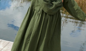 A woman in long oversized green linen dress