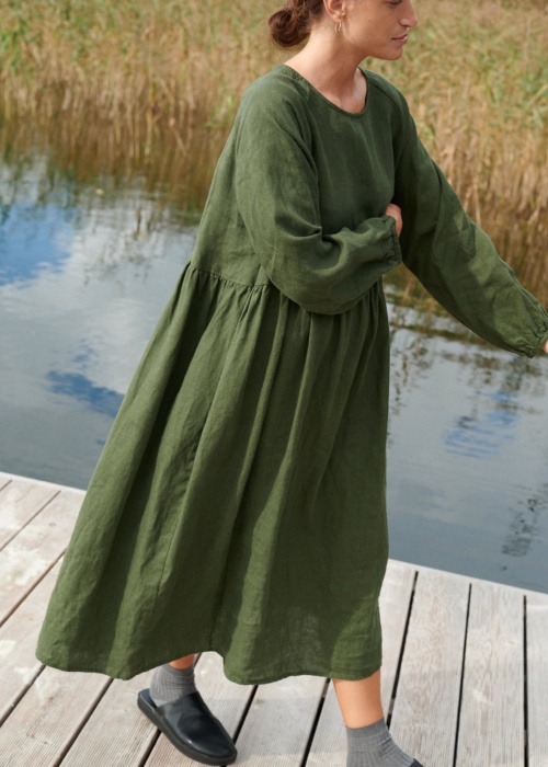 A woman in long oversized green linen dress