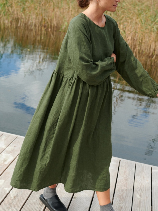 A woman in long oversized green linen dress