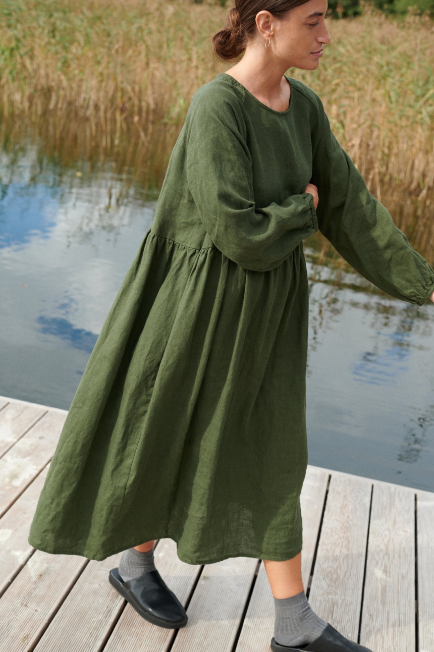 A woman in long oversized green linen dress