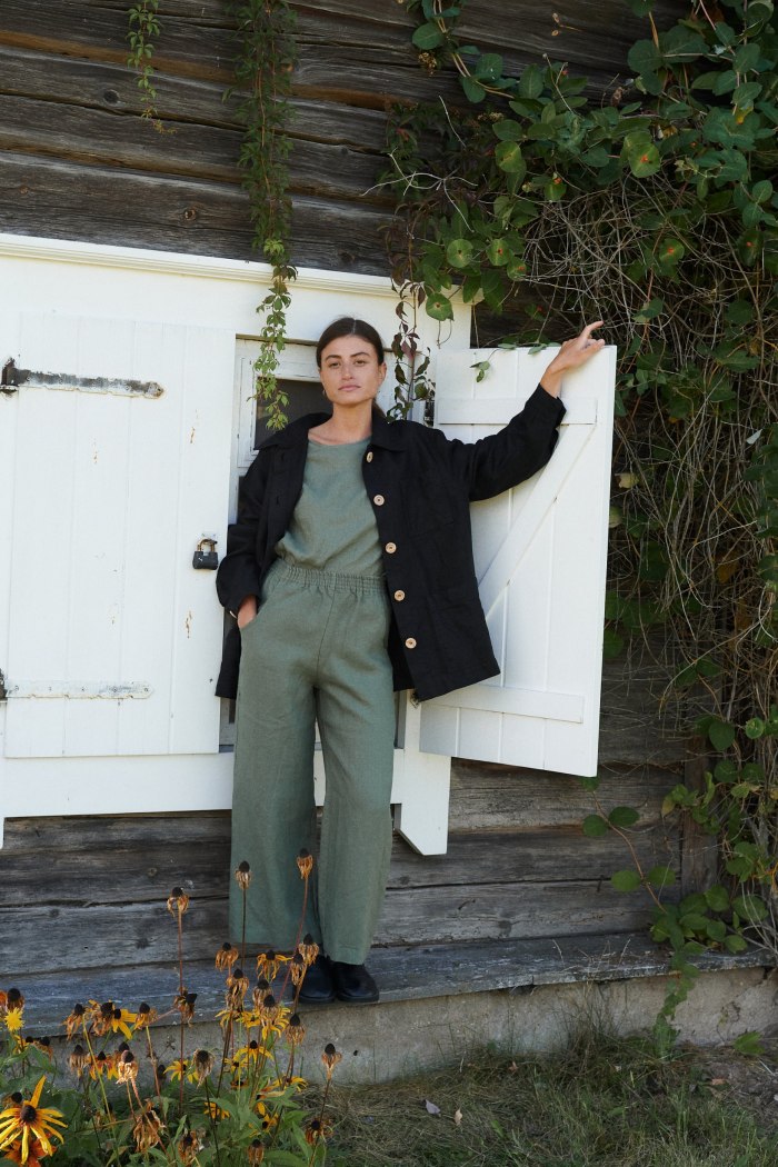 A model in green linen relaxed trousers