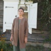 Model in an oversized brown heavy linen jacket with mid-length hem and dropped shoulders