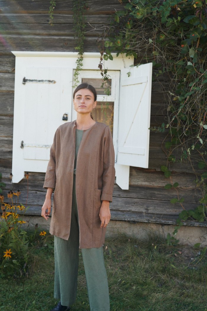 Model in an oversized brown heavy linen jacket with mid-length hem and dropped shoulders