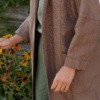 Model wearing an oversized heavy linen jacket with dropped sleeves and deep pockets