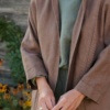 Model wearing a heavy linen jacket with high neckline and three quarter sleeves