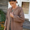 Details of an oversized fit linen jacket with three quarter sleeves, deep pockets and decorative seams