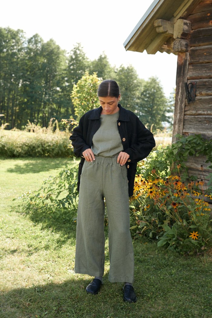 Woman wearing muted green wide leg linen trousers